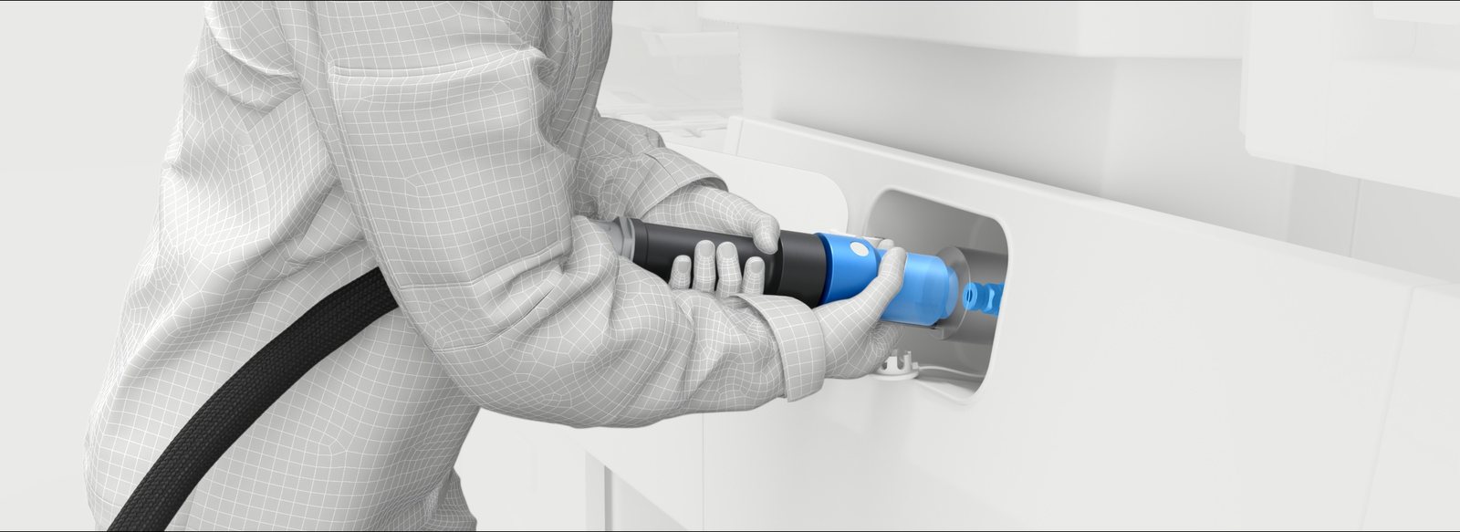 Operator in plain workwear guiding a blue nozzle toward the vehicle receptacle. The nozzle is the only coloured object in the frame.